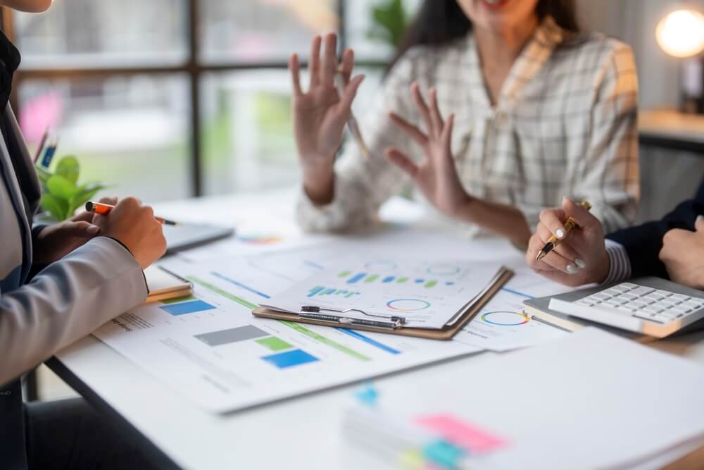 An advisor meets with two clients about business preparation tips.