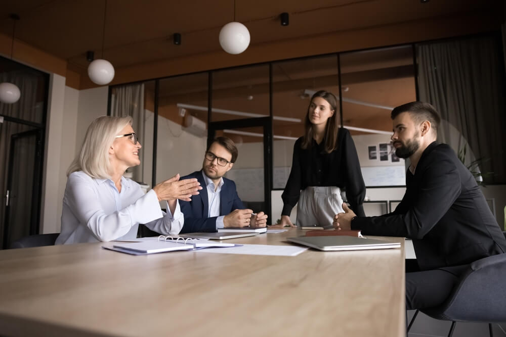 A business team in a meeting to review fractional controller services.
