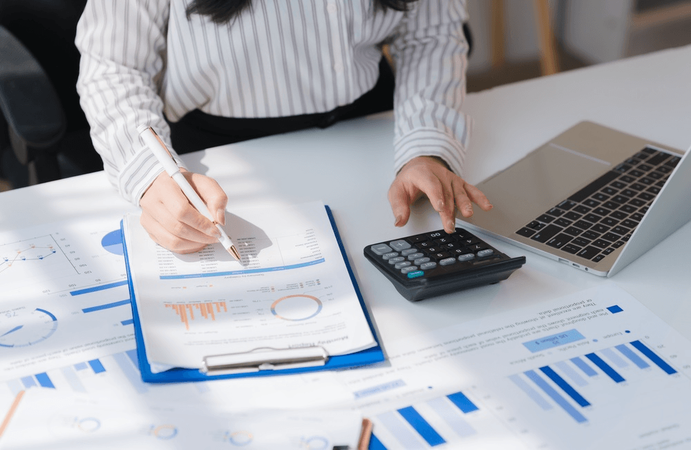 An accountant uses a month-end close checklist and calculator