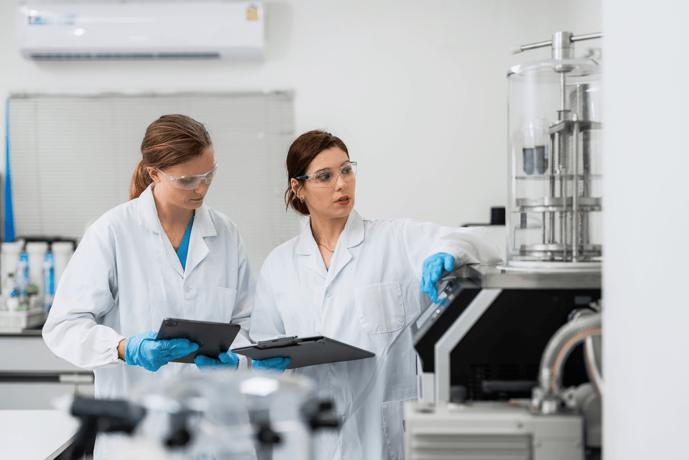 Two scientists discuss an R&D tax credit in the lab.